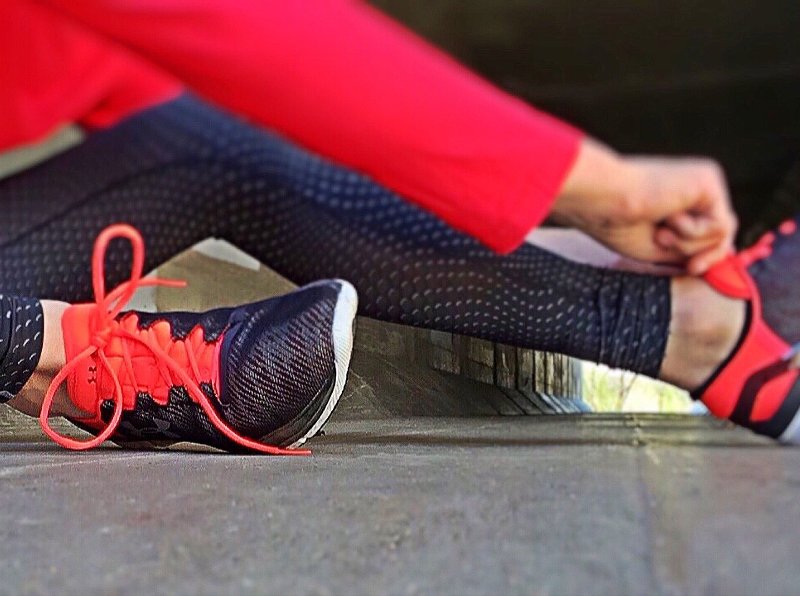 Woman adjusting sport shoes for sport rehabilitation